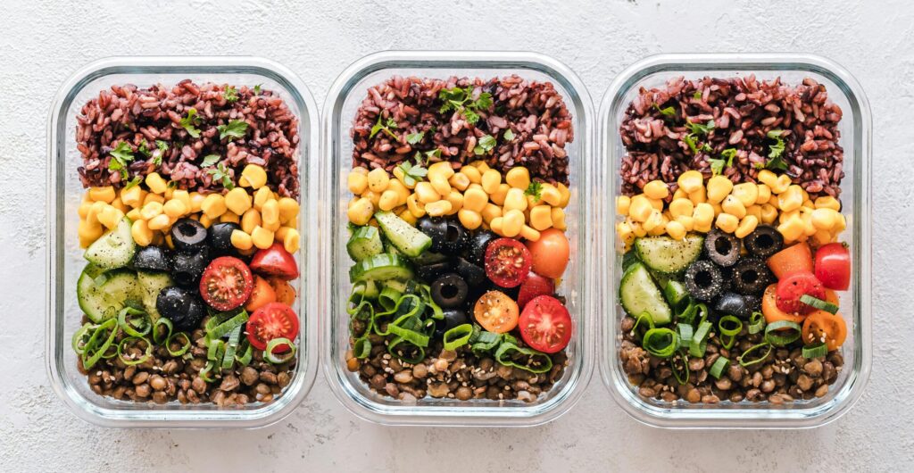 Image of meal prep, with an abundance of vegetables and grains